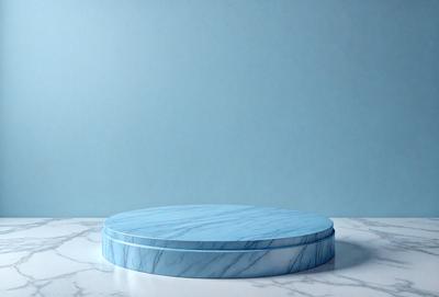 The primary subject of the image is a blue marble tabletop. The tabletop is placed on a white marble surface, which serves as the setting or background. The visual style of the image is a photo, capturing the details and colors of the marble tabletop. The dominant colors in the image are blue and white, creating a clean and elegant atmosphere.