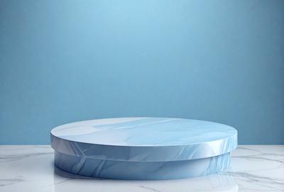 The primary subject of the image is a blue marble tabletop. The tabletop is placed on a white marble surface, which serves as the setting or background. The visual style of the image is a photo, showcasing the marble tabletop and its texture. The colors and mood of the image are predominantly blue, with the marble tabletop and the white marble surface creating a clean and elegant atmosphere.