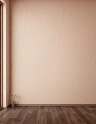 The primary subject of the image is a vase placed on a wooden floor. The setting is a room with a pink wall, and the visual style appears to be a photo. The dominant colors in the image are pink and brown, creating a warm and inviting atmosphere.