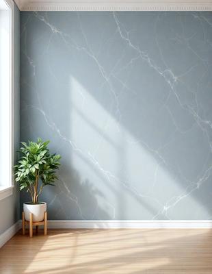 The primary subject of the image is a potted plant placed on a wooden floor. The plant is situated next to a wall, which has a marble-like texture. The setting appears to be a room with a window, providing natural light to the space. The visual style of the image is a photo, capturing the plant and the wall in detail. The colors and mood of the image are predominantly neutral, with the marble-like wall and the wooden floor creating a calm and serene atmosphere.