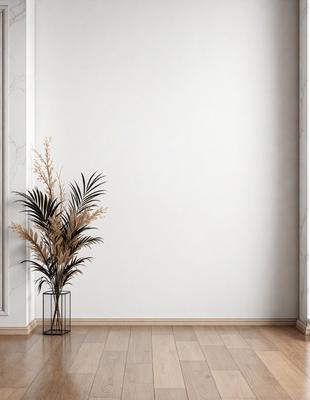 The primary subject of the image is a potted plant with a brown and green leafy plant, placed on a wooden floor. The setting is a room with a white wall, which serves as the background. The visual style is a photo, capturing the plant and its surroundings. The colors in the image are predominantly brown and green, creating a natural and calming atmosphere.