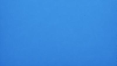 The primary subject of the image is a large, empty blue sky. The setting is a vast, open space with no clouds or other objects visible. The visual style is a realistic representation of the sky, with no indication of digital manipulation or artistic elements. The colors and mood of the image are predominantly blue, creating a calm and serene atmosphere.