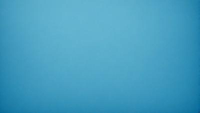 The primary subject of the image is a large, empty blue sky. The setting is a vast, open space with no visible landmarks or objects. The visual style is a natural, untouched landscape. The colors and mood are predominantly blue, creating a calm and serene atmosphere.