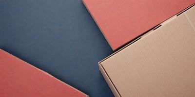 The primary subject of the image is a box, which is the main object in the scene. The box is placed on a blue surface, creating a contrast between the red box and the blue background. The visual style of the image is a photo, capturing the details of the box and its surroundings. The colors and mood of the image are predominantly red and blue, with the red box standing out against the blue background.