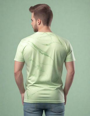 The primary subject of the image is a man wearing a green shirt. The setting is a green background, which creates a contrast with the man's shirt. The visual style appears to be a photo, capturing the man's upper body. The colors in the image are predominantly green, giving the scene a calm and relaxed atmosphere.