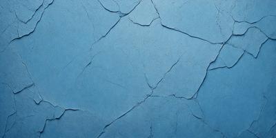 The primary subject of the image is a blue wall with a cracked and chipped appearance. The setting is a room with a blue background. The visual style is a close-up of the wall, showcasing its texture and imperfections. The colors and mood of the image are predominantly blue, giving it a calm and serene atmosphere.