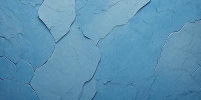 The primary subject of the image is a blue wall with a peeling paint texture. The setting is a room with a blue background. The visual style is a close-up of the blue wall with peeling paint. The dominant colors are blue and white, creating a calm and soothing atmosphere.