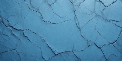The primary subject of the image is a blue wall with a cracked and chipped appearance. The setting is a room with a blue background. The visual style is a close-up of the blue wall, showcasing its texture and imperfections. The colors and mood of the image are predominantly blue, creating a calm and serene atmosphere.