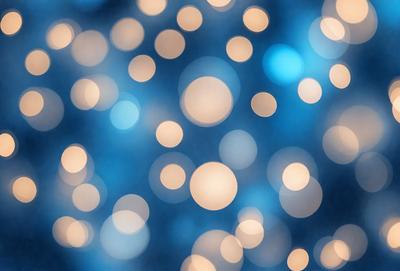 The primary subject of the image is a brightly lit, blue background with a pattern of white lights. The setting appears to be a nighttime scene, possibly a cityscape or a festive event. The visual style of the image is a combination of a photo and digital art, creating a unique and captivating atmosphere. The dominant colors are blue and white, with the white lights creating a sense of warmth and energy.