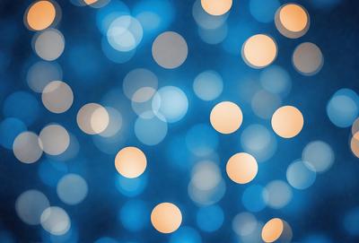 The primary subject of the image is a blue background with a pattern of yellow lights. The setting appears to be a nighttime scene, possibly a cityscape or a festive event. The visual style is a combination of digital art and illustration, creating a vibrant and lively atmosphere. The dominant colors are blue and yellow, with the blue background and the yellow lights creating a striking contrast.