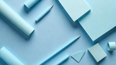 The primary subject of the image is a pencil, which is prominently displayed on a blue surface. The setting appears to be a workspace or a study area, as there are several sheets of blue paper arranged around the pencil. The visual style of the image is a combination of photo and digital art, creating a unique and creative composition. The colors and mood of the image are predominantly blue, which gives it a calm and focused atmosphere.