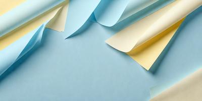 The primary subject of the image is a blue background with a variety of colored paper, including yellow, blue, and white. The setting is a blue table, and the visual style is a combination of photo and digital art. The colors and mood of the image are vibrant and lively, with the blue background providing a calm and soothing atmosphere.