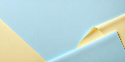 The primary subject of the image is a yellow piece of paper, which is the main focus of the scene. The setting is a blue background, which creates a contrasting and visually appealing environment. The visual style of the image is a combination of photo and digital art, giving it a unique and creative appearance. The dominant colors in the image are blue and yellow, which contribute to a lively and energetic atmosphere.