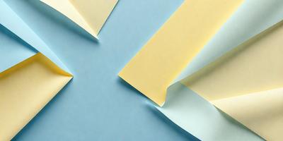 The primary subject of the image is a yellow piece of paper, which is placed on a blue surface. The setting appears to be a room with a blue table, and the visual style is a close-up of the paper. The colors and mood of the image are predominantly blue and yellow, creating a warm and inviting atmosphere.