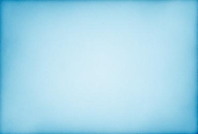 The primary subject of the image is a large, empty blue sky. The setting is a vast, open space with no visible landmarks or objects. The visual style is a natural, outdoor scene with a focus on the sky. The colors and mood are predominantly blue, creating a calm and serene atmosphere.
