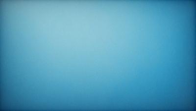 The primary subject of the image is a large, empty blue sky. The setting is a vast, open space with no visible landmarks or objects. The visual style is a natural, untouched landscape. The colors and mood are predominantly blue, creating a serene and peaceful atmosphere.