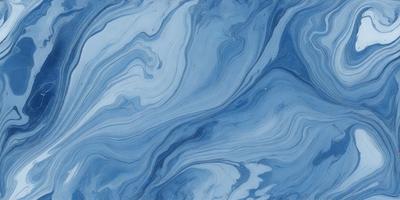 The primary subject of the image is a blue and white ocean wave. The setting is the ocean, with the wave rolling in. The visual style is a photo of the ocean, capturing the beauty of the waves. The dominant colors are blue and white, creating a serene and calming atmosphere.