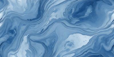 The primary subject of the image is a blue and white ocean wave. The setting is the ocean, with the wave crashing against the surface. The visual style is a photo of the ocean, capturing the beauty of the waves. The dominant colors are blue and white, creating a serene and calming atmosphere.