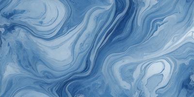 The primary subject of the image is a blue and white ocean wave. The setting is the ocean, with the wave crashing against the surface. The visual style is a photo of the ocean, capturing the beauty and power of the wave. The dominant colors are blue and white, creating a serene and calming atmosphere.