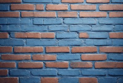 The primary subject of the image is a brick wall with a blue and red color scheme. The setting is a brick wall, and the visual style is a photo. The dominant colors are blue and red, creating a vibrant and lively atmosphere.