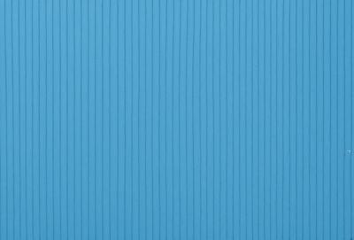The primary subject of the image is a blue wall with a wooden texture. The setting is a room with a blue wall, and the visual style is a photo. The dominant colors are blue and white, creating a calm and serene atmosphere.