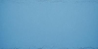 The primary subject of the image is a blue background with a pattern of white dots. The setting appears to be a blue wall or a piece of blue fabric. The visual style of the image is a close-up of the blue background, showcasing the white dots pattern. The colors and mood of the image are predominantly blue and calm, with the white dots adding a touch of contrast and interest to the background.