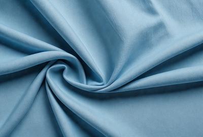 The primary subject of the image is a blue fabric, which is the main object, scene, or focus of the image. The setting or background is a blue cloth, and the visual style is a photo. The dominant colors and overall atmosphere are blue and calm.