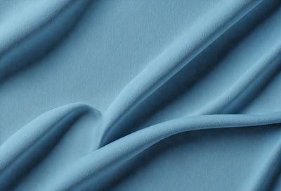 The primary subject of the image is a blue fabric, possibly a piece of cloth or a curtain. The setting is a blue background, which creates a cohesive and visually appealing scene. The visual style of the image is a close-up of the blue fabric, showcasing its texture and details. The colors and mood of the image are predominantly blue, giving it a calm and serene atmosphere.