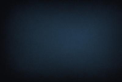 The primary subject of the image is a dark blue sky. The setting is a vast, open space with no visible landmarks or objects. The visual style is a black and white photo, which adds a sense of depth and contrast to the scene. The colors and mood of the image are predominantly dark and moody, with the blue sky serving as the main focal point.