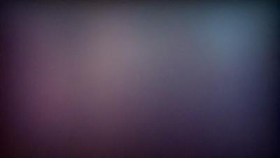 The image features a purple background with a blurry, foggy appearance. The primary subject is a large, empty space with no visible objects or details. The setting appears to be a dark, moody environment, possibly a night scene. The visual style is a close-up of the purple background, which gives the image a surreal and mysterious atmosphere.