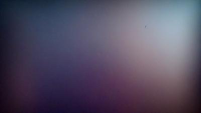 The primary subject of the image is a purple background. The setting is a dark, empty space with no visible objects or people. The visual style appears to be a photo, as it captures the purple hue and the overall atmosphere. The colors and mood of the image are predominantly purple, creating a calm and serene atmosphere.