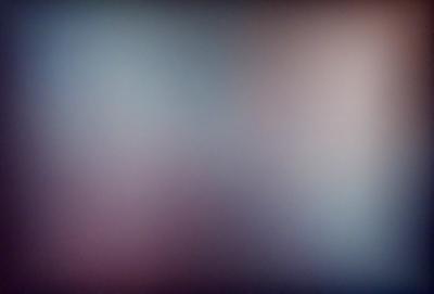 The primary subject of the image is a wall with a purple hue. The setting is a room with a purple wall, and the visual style is a photo. The dominant colors and overall atmosphere are purple and moody.