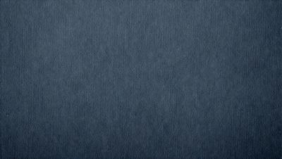The primary subject of the image is a blue fabric, which appears to be a piece of denim. The setting is a dark background, which contrasts with the blue fabric. The visual style is a close-up of the fabric, showcasing its texture and color. The colors and mood of the image are predominantly dark and moody, with the blue fabric serving as the focal point.