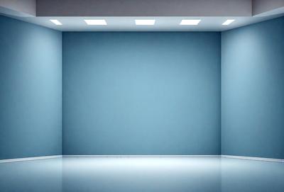 The primary subject of the image is a large, empty room with a blue wall. The setting is a white room with a blue wall, and the visual style is a photo. The colors and mood of the image are predominantly blue, creating a calm and serene atmosphere.