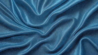 The primary subject of the image is a blue fabric, possibly a piece of clothing or a curtain. The setting is a room with a blue background, which adds to the overall atmosphere. The visual style is a close-up of the blue fabric, showcasing its texture and details. The colors and mood of the image are predominantly blue, creating a calm and serene atmosphere.