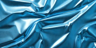 The primary subject of the image is a blue fabric, which appears to be a piece of silk. The setting is a close-up view of the fabric, showcasing its texture and color. The visual style is a realistic representation of the fabric, with no indication of digital art or illustration. The colors and mood of the image are predominantly blue, creating a calm and serene atmosphere.