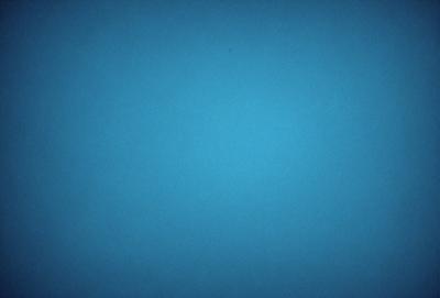 The primary subject of the image is a large, open, and dark blue sky. The setting is a vast, empty space with no visible landmarks or objects. The visual style is a natural, untouched, and unaltered representation of the sky. The colors and mood convey a sense of tranquility and vastness.