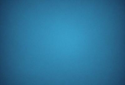 The primary subject of the image is a large, empty, and dark blue sky. The setting is a vast, open space with no visible landmarks or objects. The visual style is a natural, untouched, and unaltered representation of the sky. The colors and mood convey a sense of tranquility and vastness.