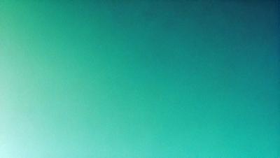 The primary subject of the image is a large, bright green wall. The setting is a dark room, and the visual style is a close-up of the green wall. The colors and mood of the image are predominantly green, creating a calm and serene atmosphere.