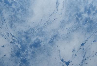 The primary subject of the image is a blue and white marbled surface, which appears to be a wall or a piece of art. The setting is a room with a blue and white marbled wall, and the visual style is a combination of a photo and digital art. The colors and mood of the image are predominantly blue and white, creating a calm and serene atmosphere.