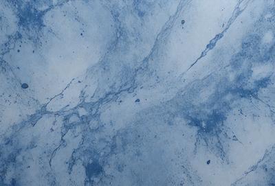 The primary subject of the image is a blue marble countertop with a pattern of swirls and bubbles. The setting is a kitchen or bathroom, as the countertop is a common surface in these areas. The visual style is a close-up of the countertop, showcasing the intricate pattern and texture. The dominant colors are blue and white, creating a calm and soothing atmosphere.