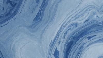 The primary subject of the image is a blue and white marbled surface, which appears to be a piece of marble or a marbled wall. The setting is a room with a blue and white marbled wall, and the visual style is a close-up of the marbled surface. The colors and mood of the image are predominantly blue and white, creating a calm and serene atmosphere.