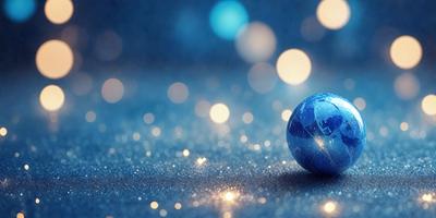 The primary subject of the image is a blue globe, which is the main object in the scene. The setting is a blue background, and the visual style is a photo. The colors and mood of the image are predominantly blue, creating a calm and serene atmosphere.
