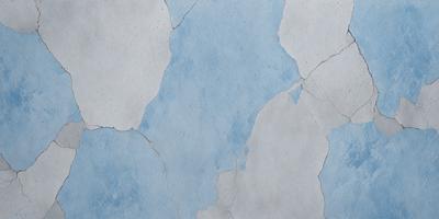 The primary subject of the image is a blue and white wall with a cracked and chipped appearance. The setting is a room with a blue and white color scheme. The visual style is a close-up of the wall, showcasing its texture and imperfections. The colors and mood of the image are predominantly blue and white, creating a calm and serene atmosphere.