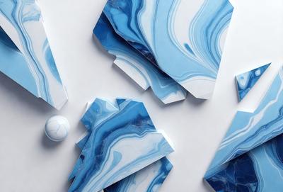 The primary subject of the image is a collection of blue and white marble-like pieces, which are displayed on a white surface. The setting appears to be a workspace or a display area, as the pieces are arranged neatly. The visual style of the image is a combination of digital art and illustration, as the marble-like pieces are created using digital tools. The dominant colors in the image are blue and white, giving the scene a clean and elegant appearance.