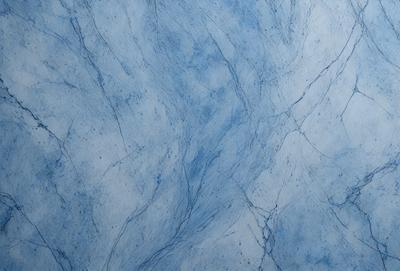 The primary subject of the image is a blue marble wall with a pattern of blue and white veins. The setting is a room with a blue marble floor. The visual style is a close-up of the marble wall, showcasing the intricate vein patterns. The colors and mood of the image are predominantly blue, creating a serene and calming atmosphere.