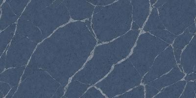 The primary subject of the image is a blue marble wall with a pattern of holes and cracks. The setting is a room with a blue tiled floor. The visual style is a close-up of the marble wall, showcasing its unique texture and design. The dominant colors are blue and grey, creating a calm and sophisticated atmosphere.