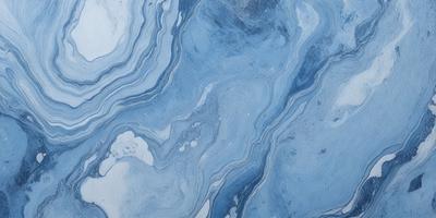 The primary subject of the image is a blue and white marbled tile. The setting is a bathroom, as indicated by the presence of the marbled tile. The visual style is a close-up of the tile, showcasing its intricate design. The dominant colors are blue and white, creating a calm and soothing atmosphere.