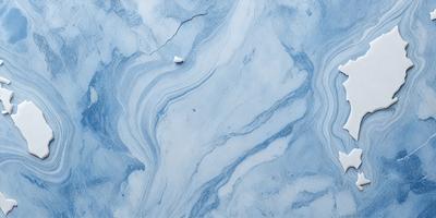 The primary subject of the image is a white toothbrush sitting on a blue and white marbled surface. The setting is a bathroom, and the visual style is a photo. The dominant colors are blue and white, creating a calm and soothing atmosphere.
