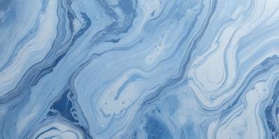 The primary subject of the image is a blue and white marbled surface, which appears to be a tile or a wall. The setting is a room with a blue and white color scheme. The visual style is a close-up of the marbled surface, showcasing its intricate patterns. The colors and mood of the image are predominantly blue and white, creating a calm and serene atmosphere.